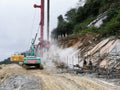 Slope support construction with excavator working