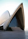 Curved and tiled shell roofs with exposed concrete beams and large glass window on outside of Sydney Opera House, Australi