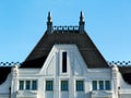 sloped residential Mansard roof with gray slate tiles. Zink sheet turrets with grounding spikes