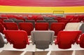 seating area detail of sport Stadium. curving rows of colorful plastic seats on steel frame.