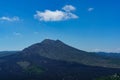 Slopes of a volcano mountain with black traces of lava with blue sky on background. Mount BaturGunung Batur on the island of Bal