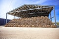 Sloping hay under a canopy. hay store