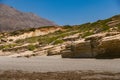 Sloping layered limestone rocks in the Mediterranean landscape on Triopetra Beach Royalty Free Stock Photo