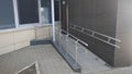 A sloping ramp with metal railings was installed to enter the municipal building for people with disabilities in wheelchairs. Thus