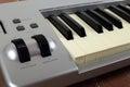 Sloseup fragment MIDI piano 61 key keyboard on a wooden background