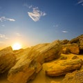 sloseup heap of huge stones in sandy desert at the sunset