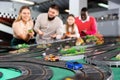 Slot car racing track. Emotional players drive toy cars Royalty Free Stock Photo