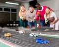 Slot car racing track. Emotional players drive toy cars Royalty Free Stock Photo