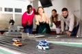 Slot car racing track. Emotional players drive toy cars Royalty Free Stock Photo