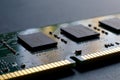 A slot key notch, contacts, connecting tracks and microchips of a computer RAM Random Access Memory modules close-up for