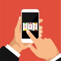 Slot machine with lucky sevens jackpot on a phone screen. Royalty Free Stock Photo