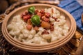 Slovak traditional dishes potato gnocchi with sheep`s cheese, on a wooden table laid on the table Royalty Free Stock Photo