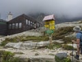 Slovakia, High Tatra mountain, September 13, 2018: Young men hiker looking at trail signpost in front of teryho chata mountain cab