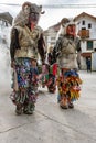 Slovene traditional carnival mask `Ta grdi` pulling the cart with burning spruce branches