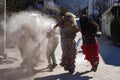 Slovene traditional carnival masks `Ta grdi` running after the teenager and throwing the ash at him