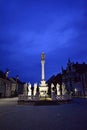 Slovenia, Maribor, Glavni trg, Main square with old plague monument at dusk