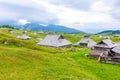 Slovenia velika planina big plateau, agriculture pasture land near city Kamnik in Slovenian Alps. Wooden houses on green land