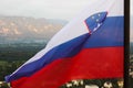 Slovenian national flag fluttering over Lake Bled Royalty Free Stock Photo