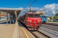 Slovenian railways electric public red and blue transport train at the railway station in Celje