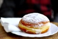 Slovenian traditional local Krapfen on a white dish on a wooden table in a bakery restaurant in Lubiana