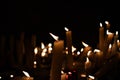 Slow burning wax candles in church as a symbol of death memory. Dark macro close composition with shallow depth of field. Royalty Free Stock Photo