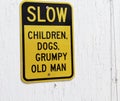 A slow children, dogs and grumpy old man sign.