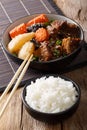 slow cooked Beef Ribs and rice garnish close-up on the table. Vertical Royalty Free Stock Photo