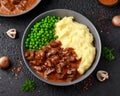 Slow Cooked Steak Diane Casserole with mushroom. mashed potatoes and green peas Royalty Free Stock Photo