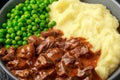 Slow Cooked Steak Diane Casserole with mushroom. mashed potatoes and green peas Royalty Free Stock Photo