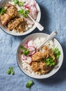 Slow cooker pork tenderloin with rice pilaf and radish salad on a blue background, top view. Royalty Free Stock Photo