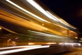 Slow exposure of a passing tram at night with light trails.