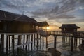 Slow exposure shot of the golden hour of the unique architectural wooden houses or villas on stilts by the sea