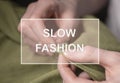 Slow fashion text over photo of tailor hands with needle and thread with textile