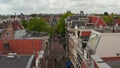 Slow forward Aerial above typicall Amsterdam Street with people shopping