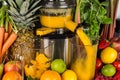 Slow juicer in kitchen with many fruit and vegetable orange vitamin juice healthy lifestyle concept background Royalty Free Stock Photo