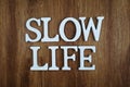 Slow Life alphabet letter with space copy on wooden background Royalty Free Stock Photo