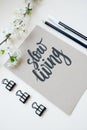 Slow living, calligraphic background with spring branch