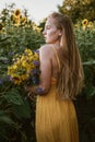 Slow Living concept New Lifestyle Trend. Relaxing young woman with lowers in nature, in corn, sunflower field Royalty Free Stock Photo