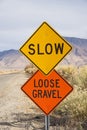 Slow And Loose Gravel Signs Along Rural Road