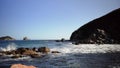 Slow mo seascape with rocks and waves.