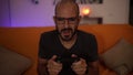 Slow Motion: man plays a video game on the sofa and loose the match. Looser sign