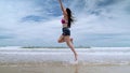 Slow motion,Beautiful Asian women jumping on the beach, freedom concept