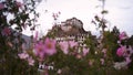 Slow motion capture of key monastery with pink flowers in foreground