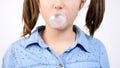 Slow motion close up portrait of cute girl chewing gum and blowing a bubblegum bubble ballon