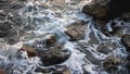 Slow Motion, close up: swells hits the rocks at sunset in Ceuta, Spain