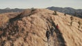 Slow motion closeup travelers hiking at mountain burnt grass aerial. Unbelievable autumn nature