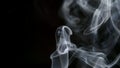 SLOW MOTION: Curve smoke lifts up on a dark background