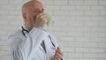 Slow Motion with Doctor Taking a Work Break Energize Drinking Hot Cup of Coffee