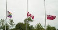 Slow motion of the flags of the LBTGQ community, Canada and the Canadian Red Ensign in the wind