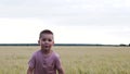 Slow Motion A Funny Little Boy Running Through A Wheat Field